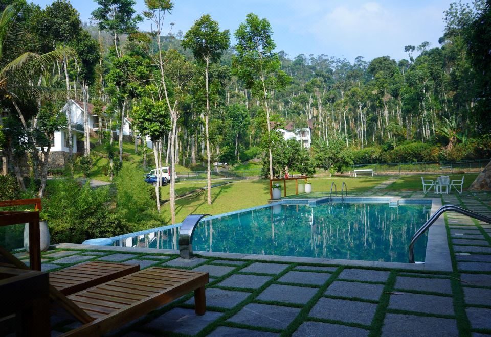 Pool overlooking the plantation cottages at Amaana Plantation Resort, Thekkady