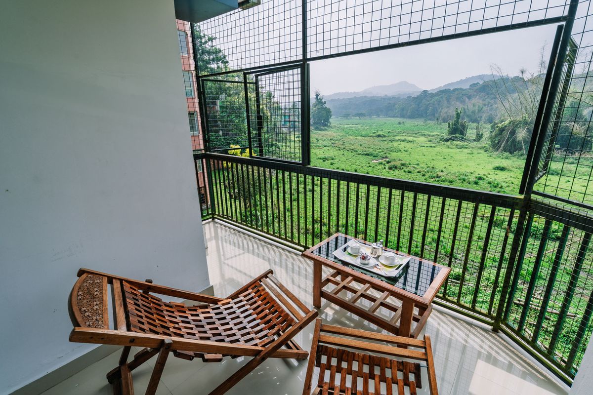 Balcony overlooking green hills at Jungle Park Resorts, Thekkady